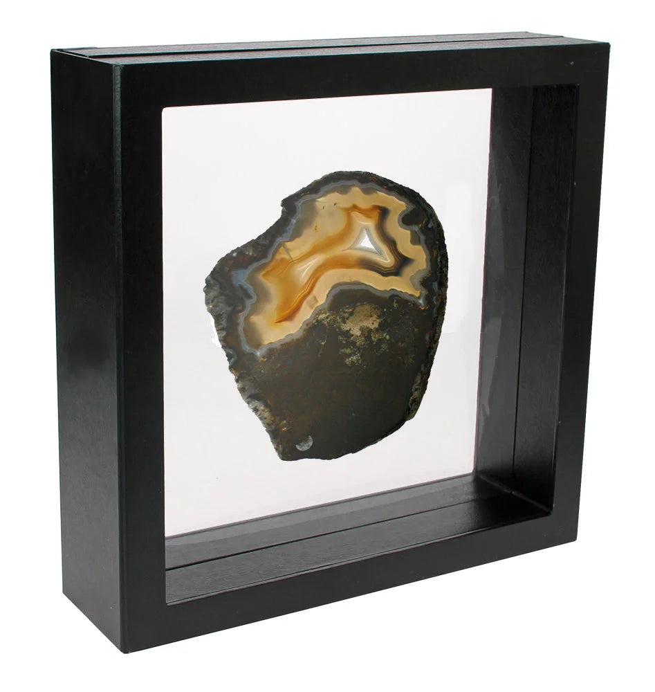 Black square frame/shadowbox with transparent window made of film that is molded to an agate slice on a white background