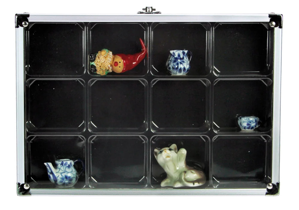 Aluminum display case with 12 compartments filled with mini ceramic collectibles, closed with an acrylic lid on a white background