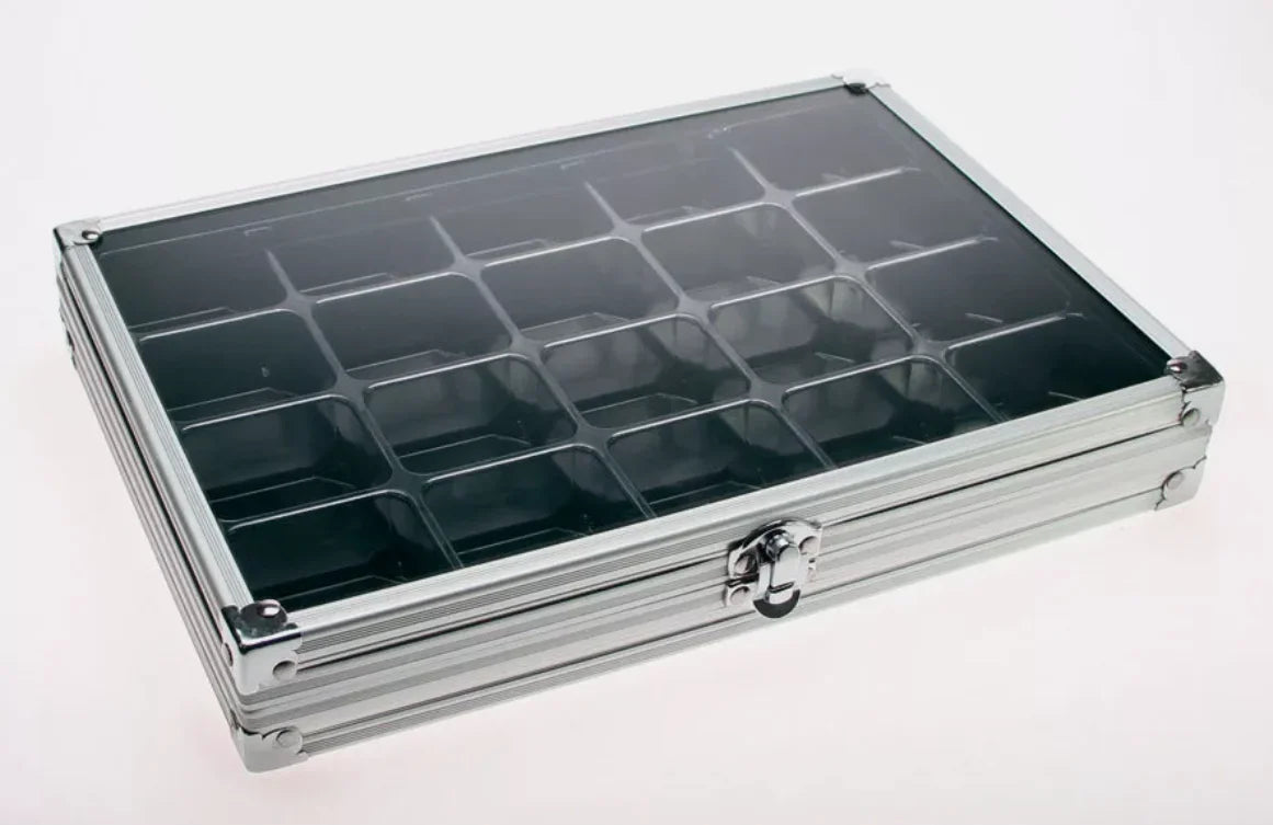 Aluminum display case with 20 compartments filled for collectibles, closed with an acrylic lid on a white background
