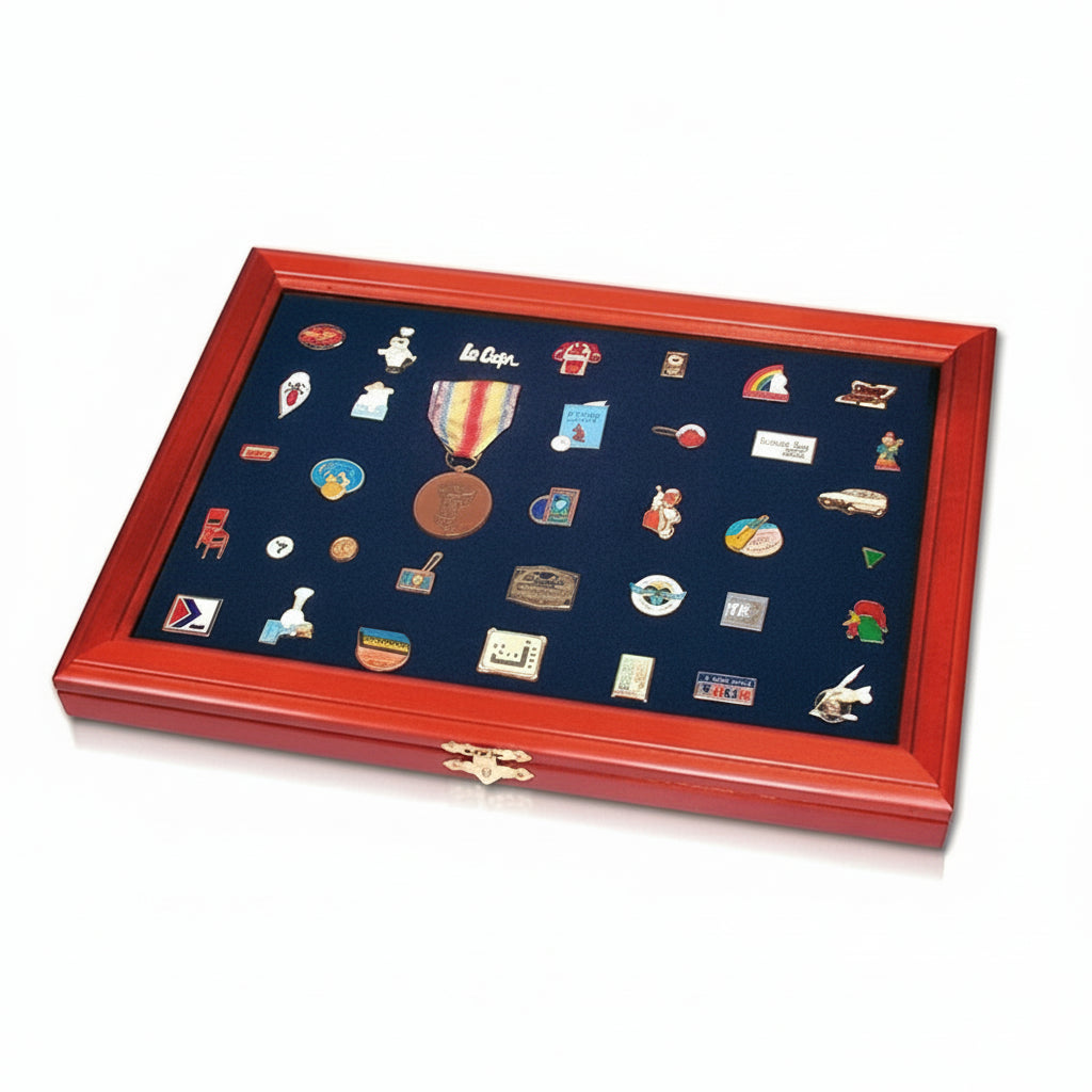 Collection of trading / collectible pins in a red wooden frame  with a blue velvet interior on a white background