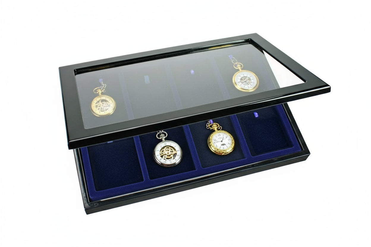 Antique pocket watches on a blue velvet tray inside of a black wooden high gloss display case with the acrylic glass lid open ajar on a white background