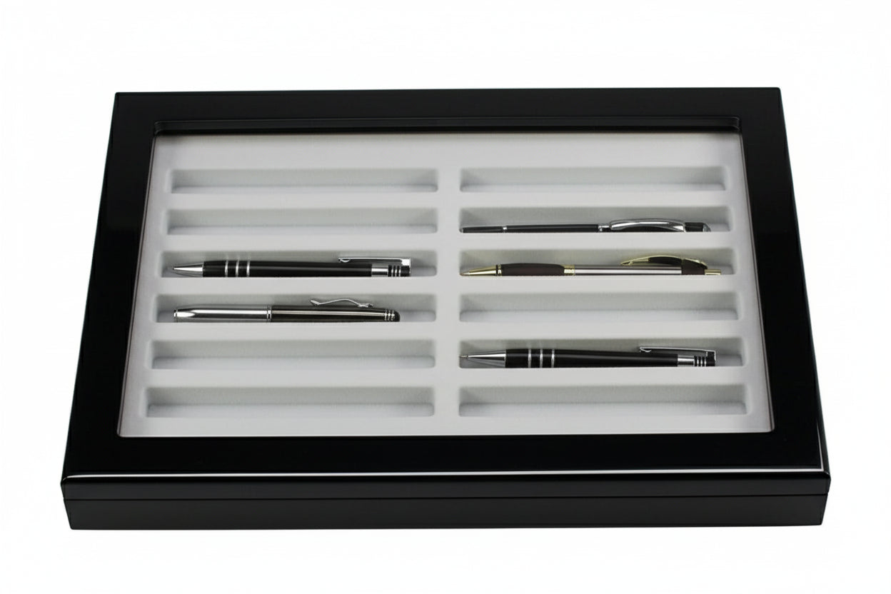 Set of pens in a black wooden high gloss display case with a beige/grey tray insert and an acrylic glass lid on a white background