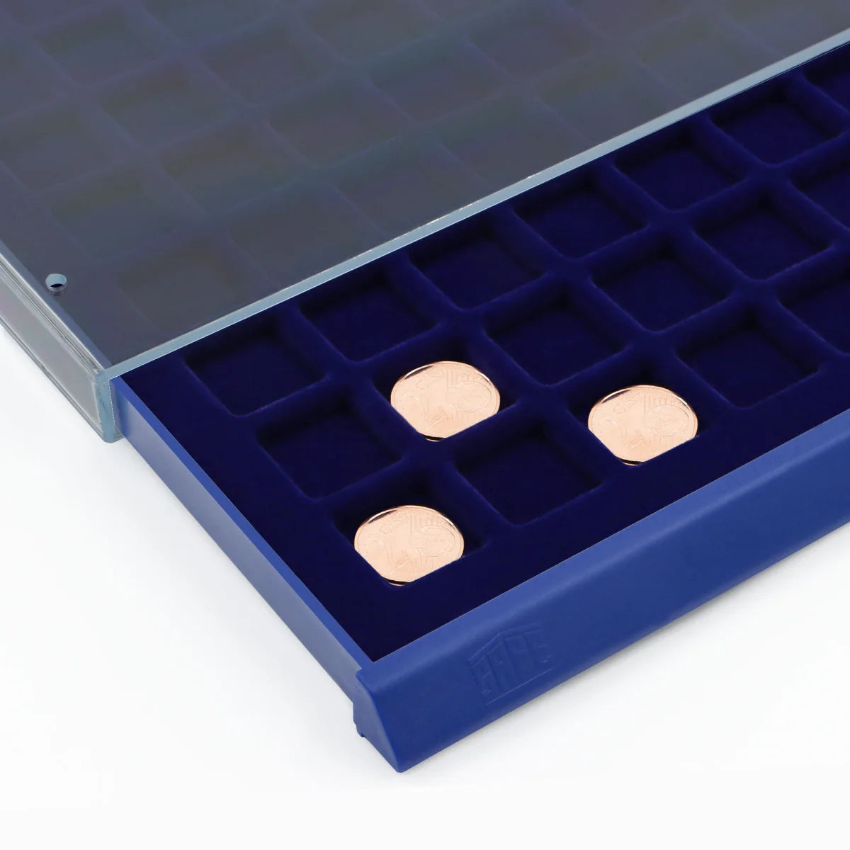 Detail image of open acrylic stackable drawer unit with a blue velvet tray and square compartments with coins on a white background