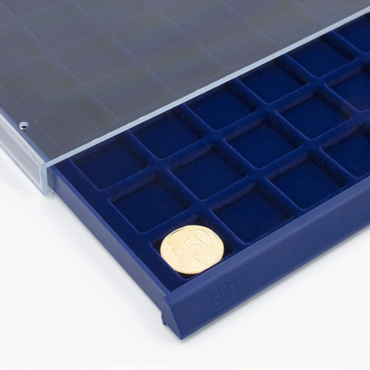 Detail image of open acrylic stackable drawer unit with a blue velvet tray and square compartments with coins on a white background