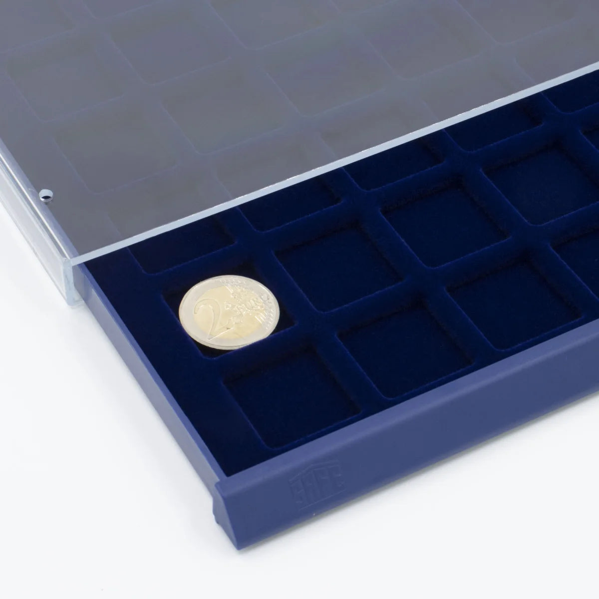 Detail image of open acrylic stackable drawer unit with a blue velvet tray and square compartments with coins on a white background