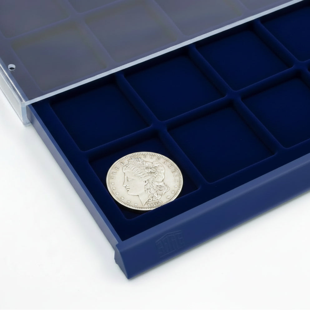 Detail shot of open acrylic stackable drawer unit with a blue velvet tray and square compartments holding morgan dollar coin on a white background