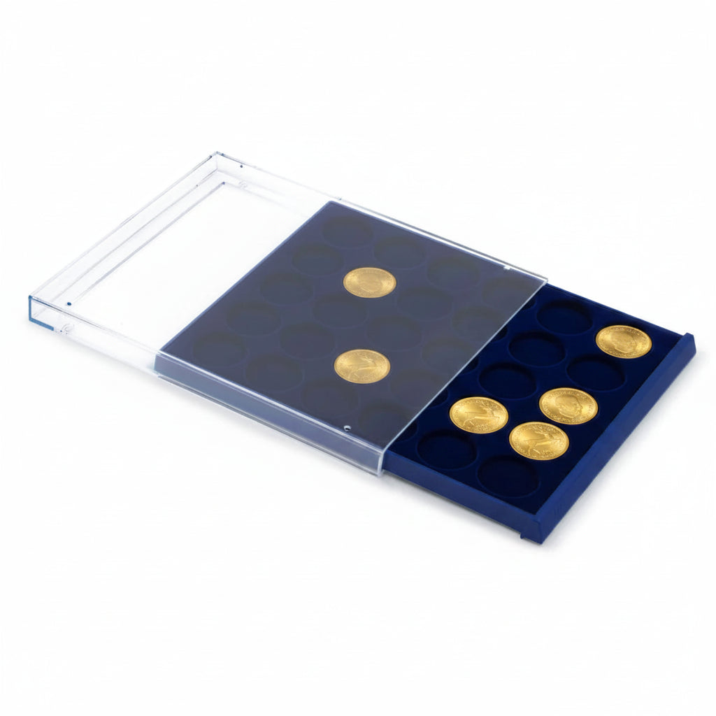Open acrylic stackable drawer unit with a blue velvet tray and circular compartments holding gold coins on a white background