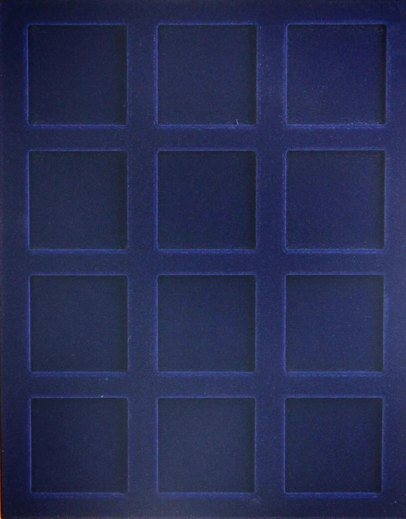 A blue velvet coin tray with 12 square compartments