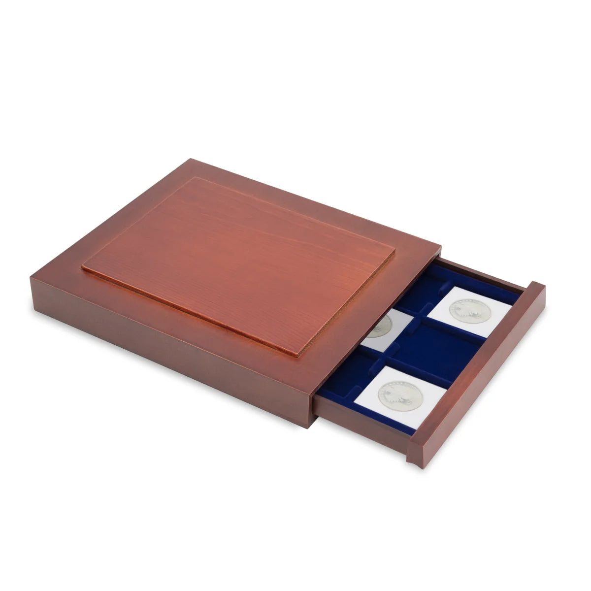 Open wooden stackable drawer unit from with a blue velvet tray with square compartments with 2x2 coin flips on a white background