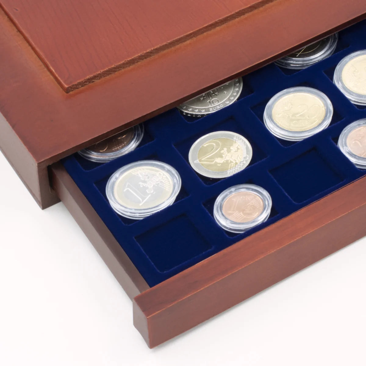 Detail shot of open wooden stackable drawer unit with a blue velvet tray for mixed coin collections on a white background