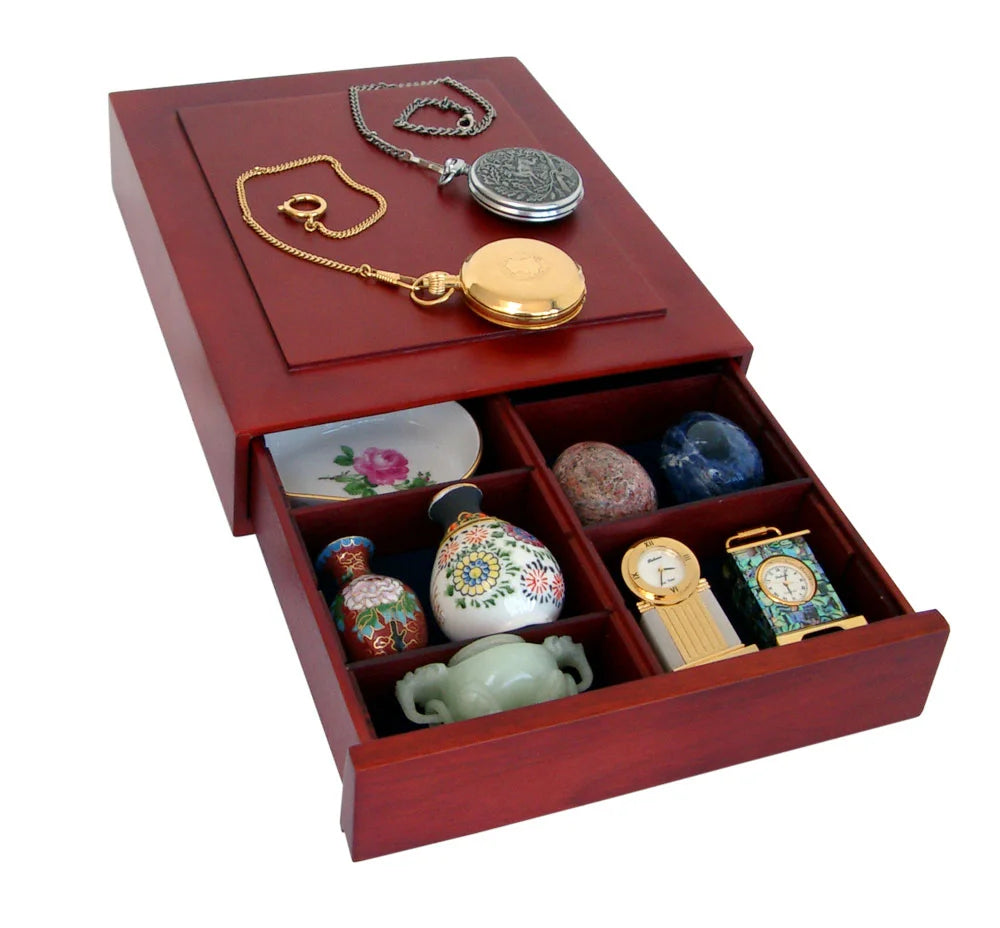 Open wooden stackable drawer with various collectible items on a white background
