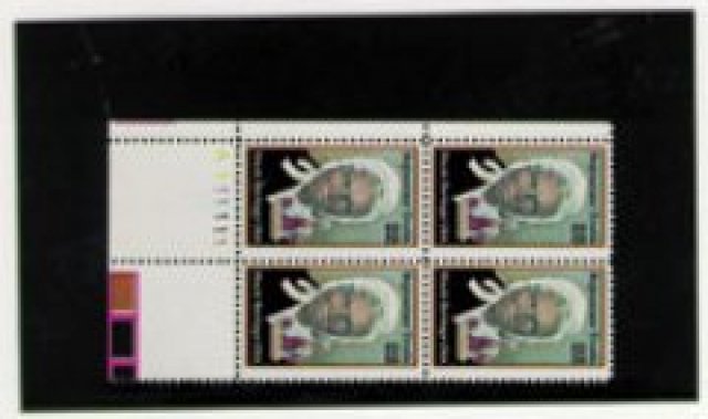 Plate block stamps inside a black approval card on a white background