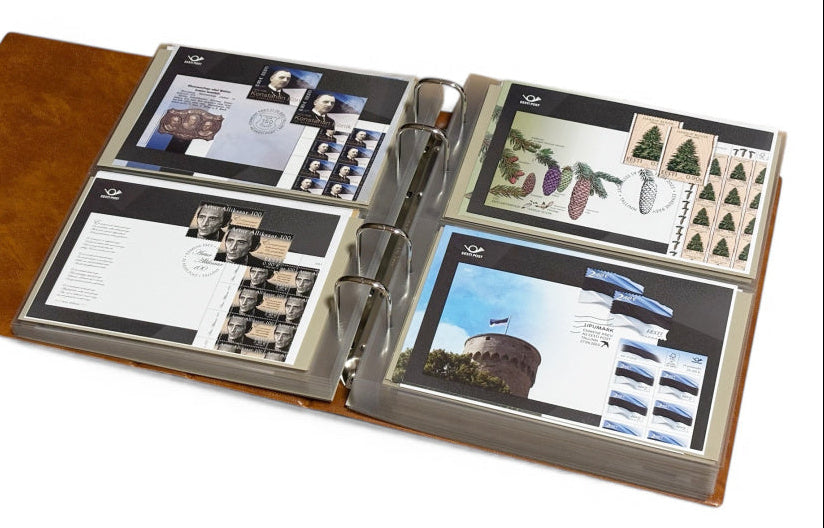 Tan stamp album laid open with transparent pages displaying stamps  & covers on a white background
