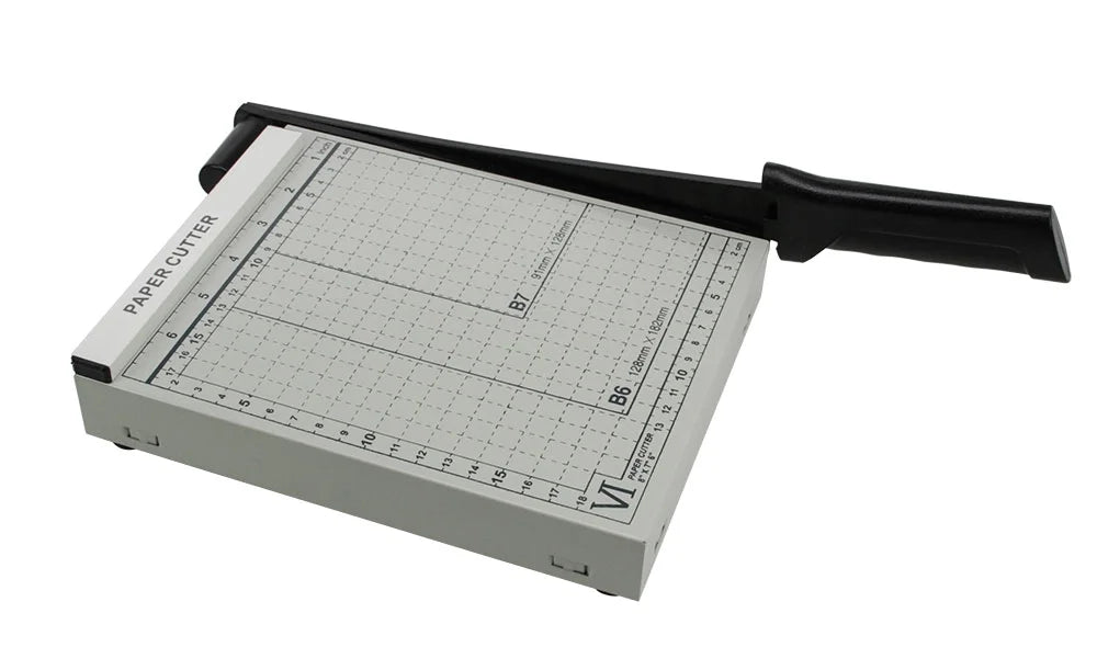 Grey measuring table and black handle paper cutter on a white background