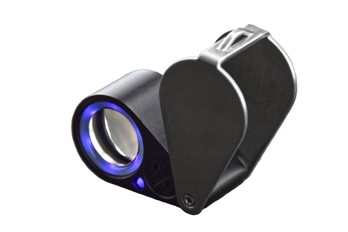 Handheld loupe magnifier with UV/LED ring light turned on, on a white background