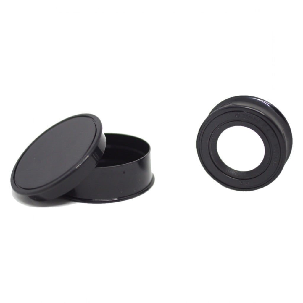 A twist to open circular magnifying lens, not expanded, next to the protective black case on a white background