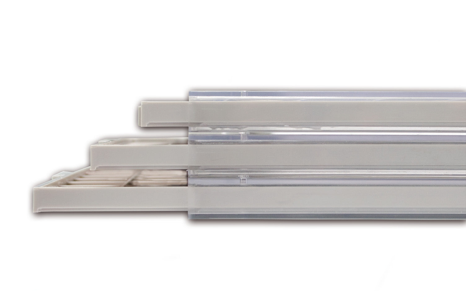 Detail shot from the side, of the three stacked coin storage drawers open ajar on a white background.