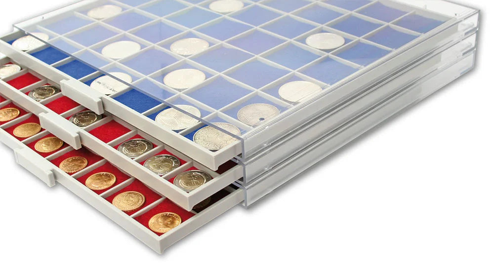 Stack of coin storage drawer units with a clear acrylic casing and a grey drawer with blue/red felt inserts & silver coins on a white background.