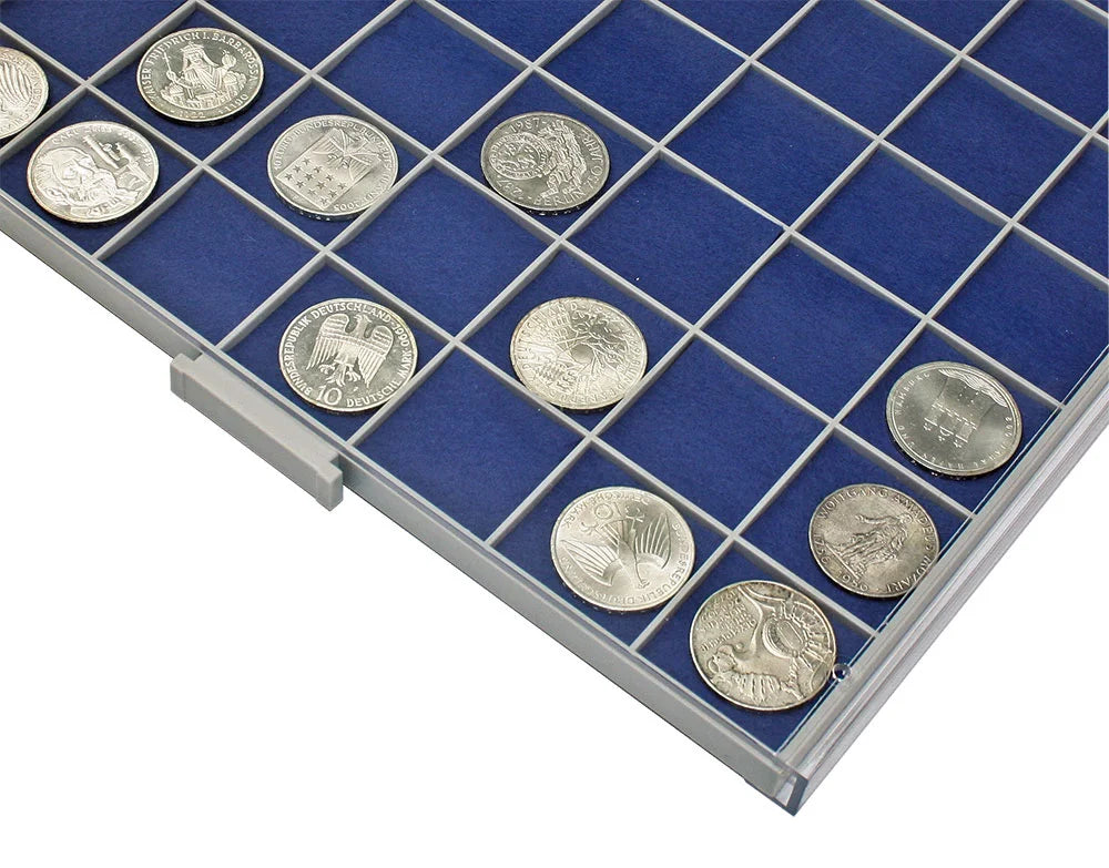 detail shot of the gray grid tray drawer with blue felt inserts and silver coins on a white background