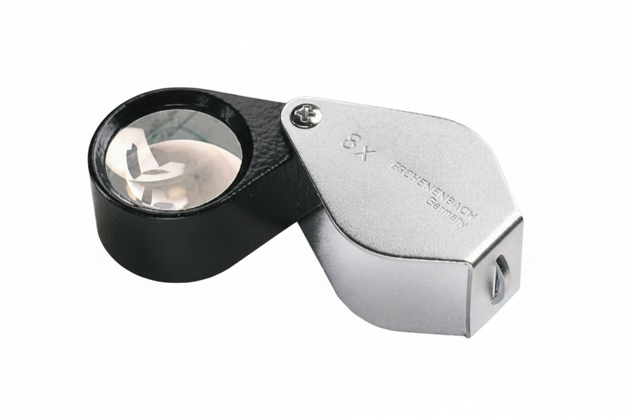 8x Magnifying glass loupe with a black body and silver handle on a white background