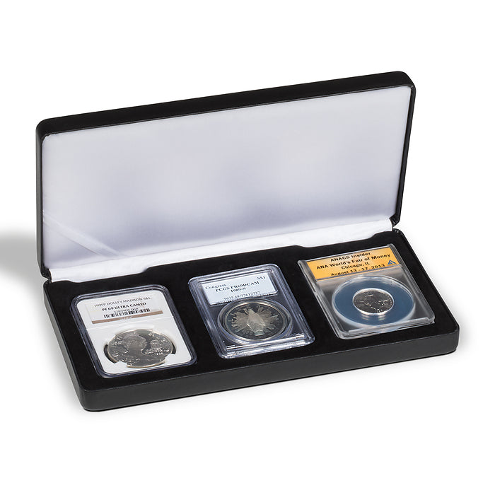 Open black coin case with a white silky interior displaying three graded coin slabs on a black insert on a white background