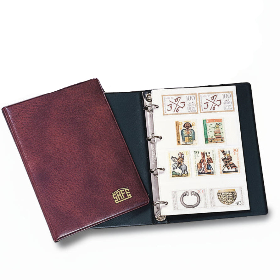 Two stamp stockbooks laid open showing the white refill pages with clear stamp strips.